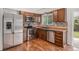 Modern kitchen with stainless steel appliances, sleek countertops, and wood cabinetry at 1962 S Ivory Way, Aurora, CO 80013