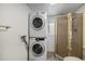 In unit laundry room featuring a stacked washer and dryer with a full bathroom at 1962 S Ivory Way, Aurora, CO 80013