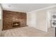 Living room featuring a brick fireplace and easy access to in-unit washer and dryer at 1962 S Ivory Way, Aurora, CO 80013
