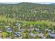 Aerial view of homes in the community with trees at 31412 N Bermuda Dunes Dr, Evergreen, CO 80439