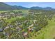 Expansive aerial view showcases a charming community nestled among trees and a serene lake at 31412 N Bermuda Dunes Dr, Evergreen, CO 80439
