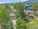 Aerial view of a home with mature trees, lush landscaping, and a two car garage at 31412 N Bermuda Dunes Dr, Evergreen, CO 80439