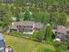 Aerial view of a landscaped backyard with a wooden fence in a mature neighborhood at 31412 N Bermuda Dunes Dr, Evergreen, CO 80439