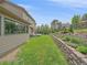 Manicured backyard with lush green lawn, retaining wall, and tasteful landscaping at 31412 N Bermuda Dunes Dr, Evergreen, CO 80439