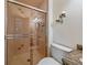 Bathroom boasts a glass shower, patterned tile, and vanity with candle sconces at 31412 N Bermuda Dunes Dr, Evergreen, CO 80439