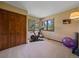 Bedroom featuring a large closet, home gym equipment, and windows with backyard views at 31412 N Bermuda Dunes Dr, Evergreen, CO 80439