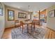 Dining room with view to the living room, hardwood floors and a stylish area rug at 31412 N Bermuda Dunes Dr, Evergreen, CO 80439