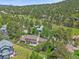 Beautiful aerial view of home with a deck surrounded by a wooden fence and lush green lawn at 31412 N Bermuda Dunes Dr, Evergreen, CO 80439