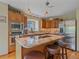 Lovely kitchen featuring granite counters, wooden cabinets, stainless steel appliances, and island seating at 31412 N Bermuda Dunes Dr, Evergreen, CO 80439