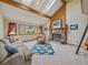 Cozy living room featuring a stone fireplace, skylights, and a comfortable seating area at 31412 N Bermuda Dunes Dr, Evergreen, CO 80439