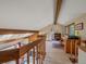 Upstairs loft space with wood beams, skylights, and a home office area with great views at 31412 N Bermuda Dunes Dr, Evergreen, CO 80439