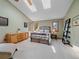 This main bedroom features high ceilings, skylights, and an elegant metal bed frame at 31412 N Bermuda Dunes Dr, Evergreen, CO 80439