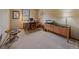 The office area has wood desk, cabinets, and neutral carpeting at 31412 N Bermuda Dunes Dr, Evergreen, CO 80439