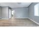 Spacious empty room with hardwood floors, neutral paint, and natural light from a window at 361 N Raleigh St, Denver, CO 80219