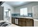Updated kitchen showcasing stainless steel dishwasher, dual sink, in unit washer dryer and dining room access at 361 N Raleigh St, Denver, CO 80219