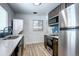 Bright kitchen with stainless steel appliances, stunning blue tile backsplash, and in-unit laundry at 361 N Raleigh St, Denver, CO 80219