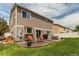 Landscaped backyard featuring a patio, well-maintained lawn, and privacy fence for outdoor enjoyment and entertaining at 5400 Perth St, Denver, CO 80249