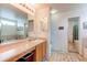 Spacious bathroom with a double vanity, large mirror, and separate tub and shower areas at 5400 Perth St, Denver, CO 80249