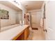 Hall bathroom with tub and shower combination, framed mirror, and vanity at 5400 Perth St, Denver, CO 80249