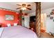 Ornate bedroom with unique four-poster bed, red walls, and an attached bathroom at 5400 Perth St, Denver, CO 80249