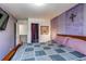 Bedroom featuring a bed, accent chair, mounted TV, and patterned walls at 5400 Perth St, Denver, CO 80249
