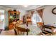 Charming dining area with wooden chairs and table, decorative hutch, and cozy lighting perfect for Gathering meals at 5400 Perth St, Denver, CO 80249