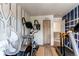 Spacious home gym featuring an elliptical machine, treadmill, and sports-themed decor at 5400 Perth St, Denver, CO 80249