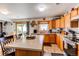 Cozy eat-in kitchen with breakfast bar, stainless appliances, and sliding glass door to backyard at 5400 Perth St, Denver, CO 80249