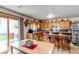 Eat-in kitchen with stainless appliances, breakfast bar, and backyard access at 5400 Perth St, Denver, CO 80249