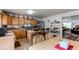 Eat-in kitchen with stainless appliances, breakfast bar, and view to living room at 5400 Perth St, Denver, CO 80249