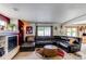 Cozy living room with fireplace, ample seating, and backyard access at 5400 Perth St, Denver, CO 80249