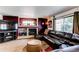 Inviting living room area with fireplace, media center, and comfortable seating at 5400 Perth St, Denver, CO 80249
