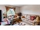 Cozy living room featuring comfortable seating, natural light, and a decorative rug at 5400 Perth St, Denver, CO 80249