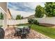 Patio featuring outdoor table and chairs, a grill, a large tree, and privacy fence for outdoor dining and relaxation at 5400 Perth St, Denver, CO 80249