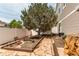 Landscaped side yard with stone pathway, flower bed, and a large tree providing shade and beauty to the property at 5400 Perth St, Denver, CO 80249