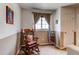 Cozy sitting room with natural light from window and rocking chair at 5400 Perth St, Denver, CO 80249