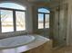 Bathroom with soaking tub, shower, and lake view at 6297 W Prentice Ave, Littleton, CO 80123