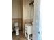 Elegant powder room with patterned wallpaper and new vanity at 6297 W Prentice Ave, Littleton, CO 80123