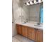 Double vanity bathroom with wood cabinets and mirror at 6297 W Prentice Ave, Littleton, CO 80123