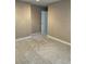 Empty carpeted bedroom with neutral walls and a door at 6297 W Prentice Ave, Littleton, CO 80123