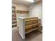 Large closet with wooden shelves offering ample storage at 6297 W Prentice Ave, Littleton, CO 80123