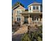 Two-story house featuring a wrap-around porch and bay window at 6297 W Prentice Ave, Littleton, CO 80123