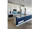 Modern kitchen with white cabinets, granite countertops and a large island at 6297 W Prentice Ave, Littleton, CO 80123