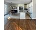 Open concept living area with hardwood floors and kitchen access at 6297 W Prentice Ave, Littleton, CO 80123