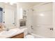 Neat bathroom with a combined shower and tub, along with a functional vanity, offering practical space utilization at 3415 Florence Way, Denver, CO 80238