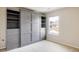Bright bedroom featuring a built-in murphy bed with shelving and drawers, maximizing space and functionality at 3415 Florence Way, Denver, CO 80238