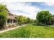 View of the manicured front lawn and community walking path, enhancing the curb appeal and neighborhood feel at 3415 Florence Way, Denver, CO 80238