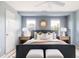 Comfortable main bedroom with blue walls, stylish decor, and windows offering natural light at 3415 Florence Way, Denver, CO 80238