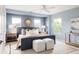 Serene main bedroom with blue walls, a ceiling fan, and a comfortable upholstered bed at 3415 Florence Way, Denver, CO 80238