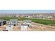 Wide aerial shot showcasing a community with manicured lawns, walking path, and mountain views at 11033 Olathe St, Commerce City, CO 80022